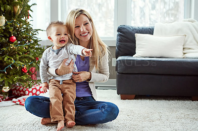 Buy stock photo Mother, baby and happy christmas while on floor in living room, holiday and bonding for love. Motherhood, parent and toddler with woman together, hug and play with sitting or pointing at home