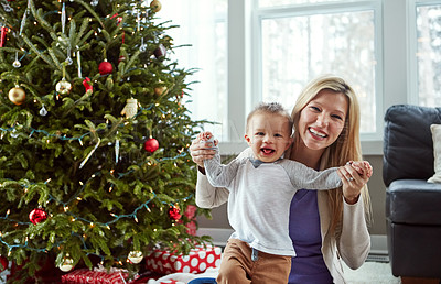 Buy stock photo Portrait, baby and mother with christmas in living room, holding hands for love and holiday. Smile, toddler with woman together and motherhood, hug and play by sitting for relationship at home