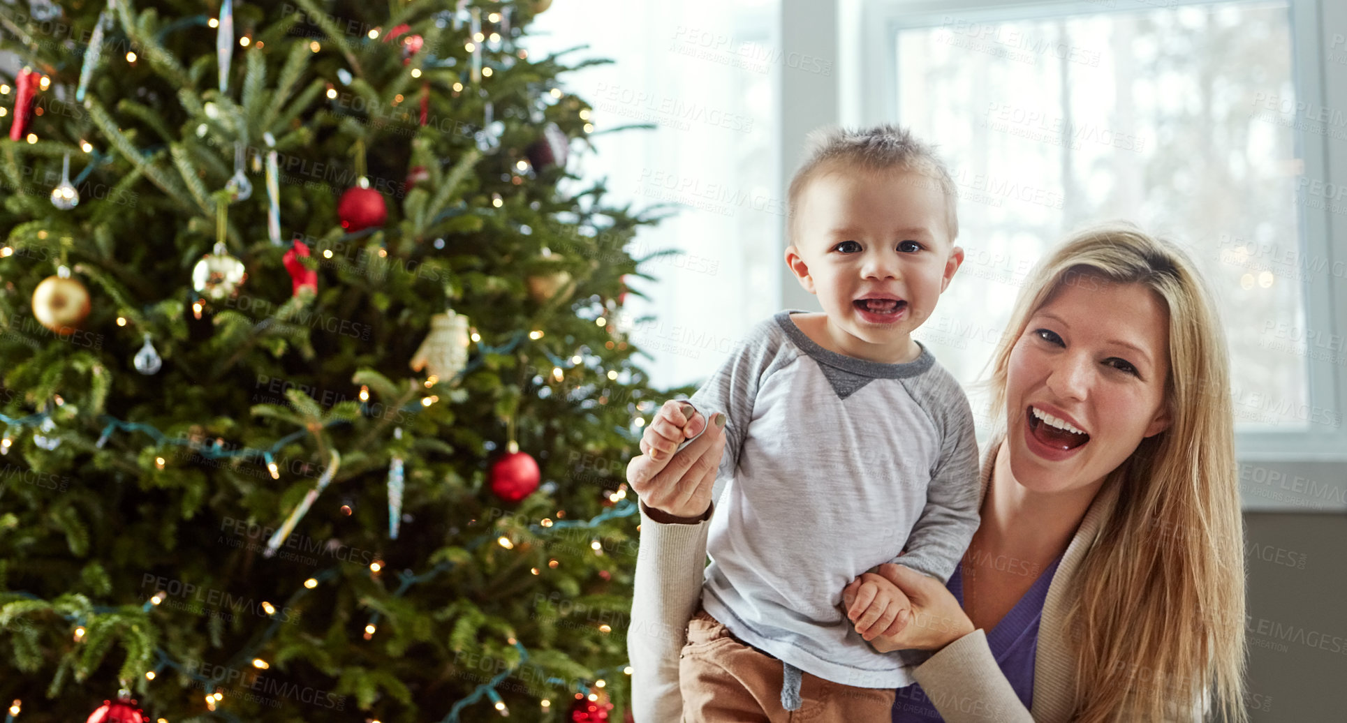 Buy stock photo Portrait, baby and happy with mother in living room, holding hands for love and christmas holiday. Smile, motherhood and toddler by woman together, hug and play by sitting for relationship at home