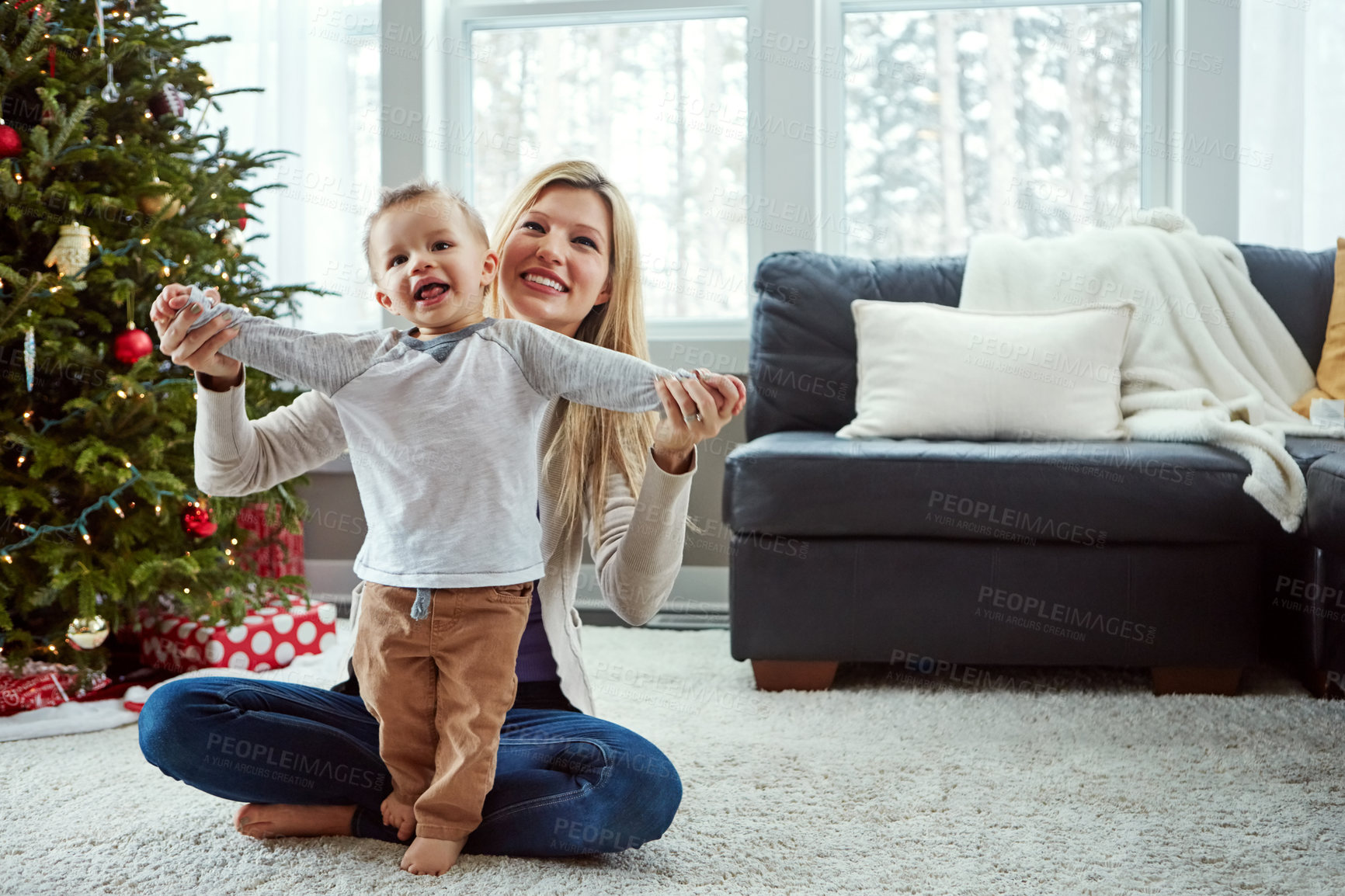 Buy stock photo Mother, baby and happy family for christmas on floor in living room, holding hands for holiday and love. Smile, motherhood and toddler with woman together, play and hug for relationship at home