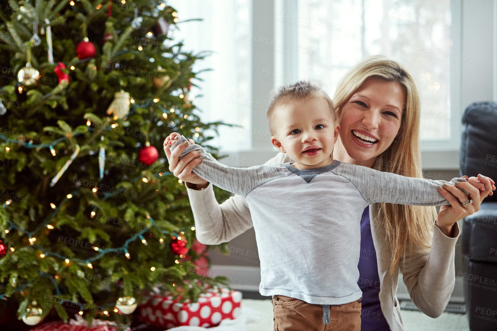 Buy stock photo Portrait, child and woman for Christmas, tree and hold hand for bonding celebration together. Smile, trust for baby and family sit on floor, motherhood happiness and festive hugs for toddler at home