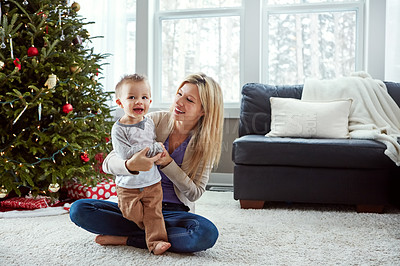 Buy stock photo Smile, woman and christmas with child in living room by mother, play and laugh for bonding together. Love, laughing with baby or family sit on floor, motherhood happiness and hugs for toddler at home