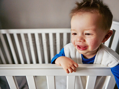 Buy stock photo Cute, happy and baby in family home crib for child development, fun and thinking. Toddler, sweet and playful for cheerful gentle boy relaxing on a bed in his nursery or innocent bedroom cradle