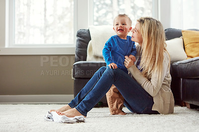 Buy stock photo Home, smile and hug of baby by mom, living room and playful with son, love and care in apartment. House, woman and toddler in lounge, mother and child together, happiness and wellness for boy