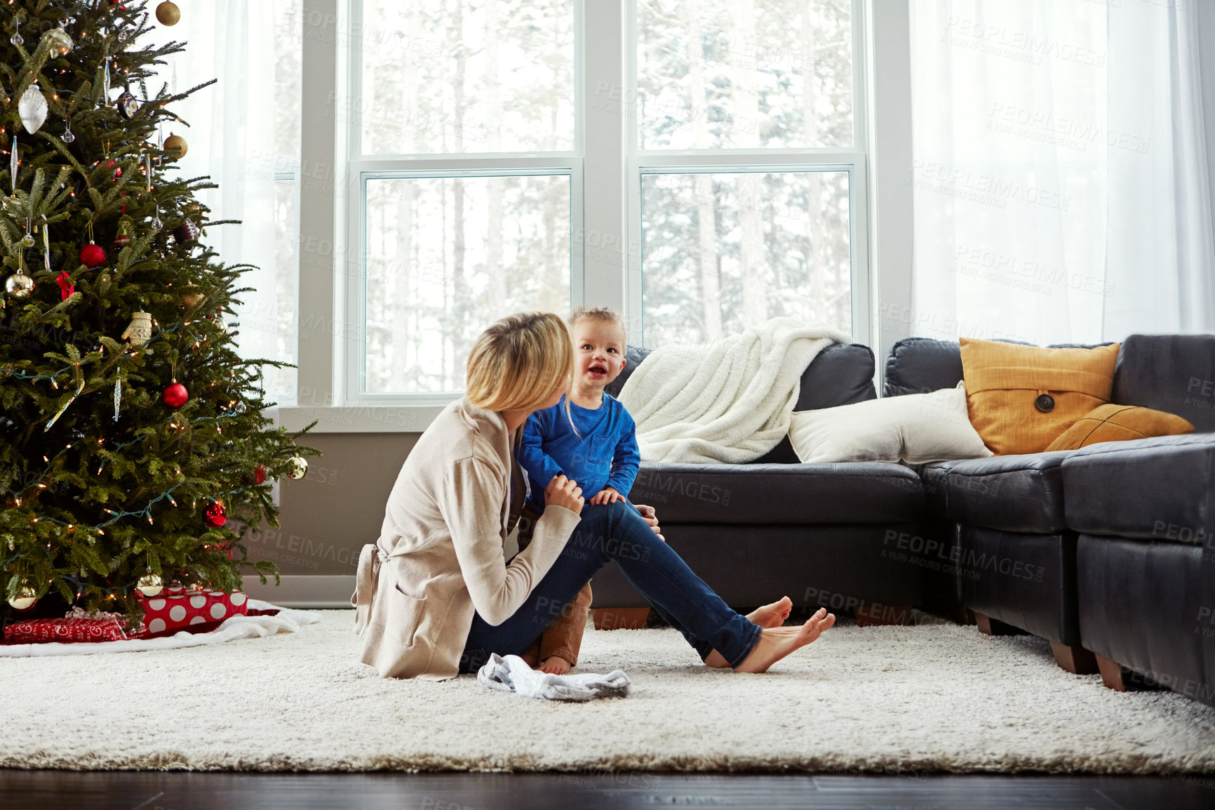 Buy stock photo Home, smile and mom with toddler in Christmas, living room and playful with son, love and care in apartment. House, mother and child in lounge, tree and fun together, happiness and wellness for boy