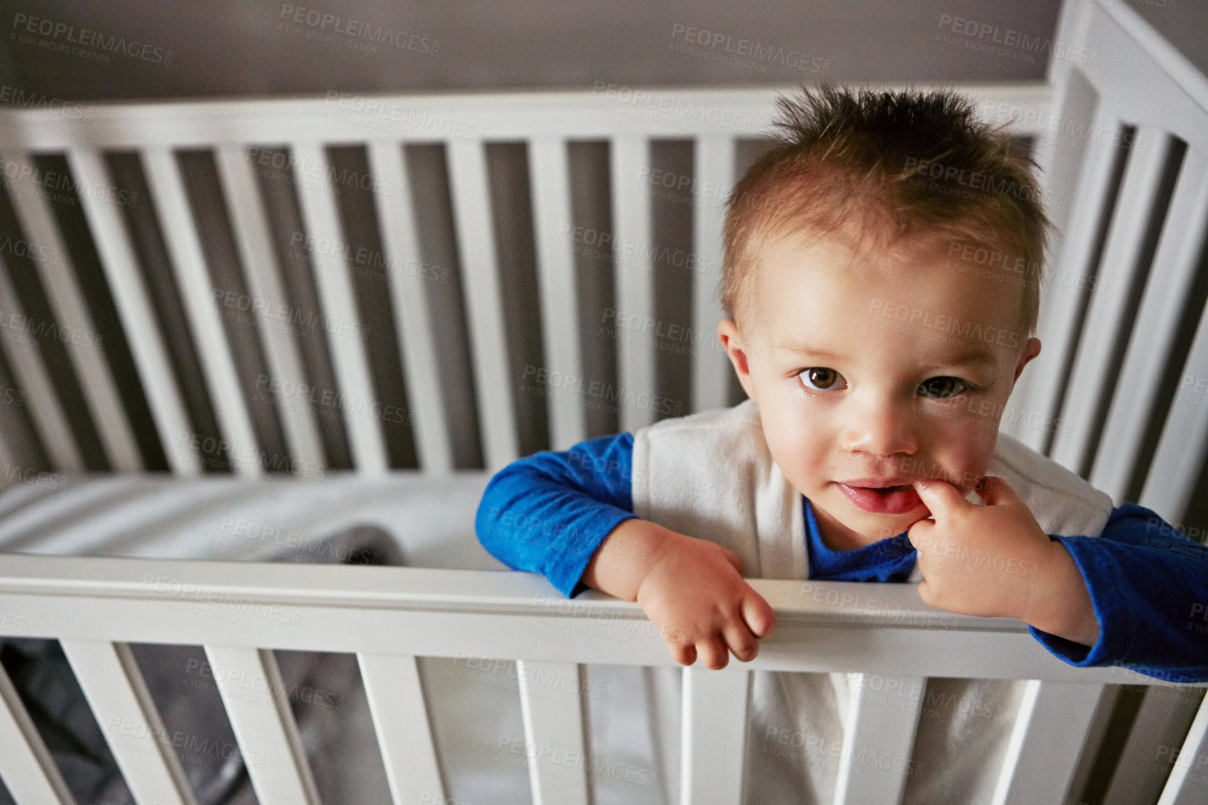 Buy stock photo Portrait, happy and playful baby in crib on a blanket for child development, fun and entertainment. Happy, sweet and newborn for cheerful infant boy relaxing on a bed in his nursery or bedroom home