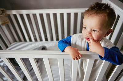 Buy stock photo Wake up, curious and thinking kid in cute crib for child development, rest and childhood. Morning, care and innocent baby or young boy relaxing on a bed in his nursery or home bedroom cradle