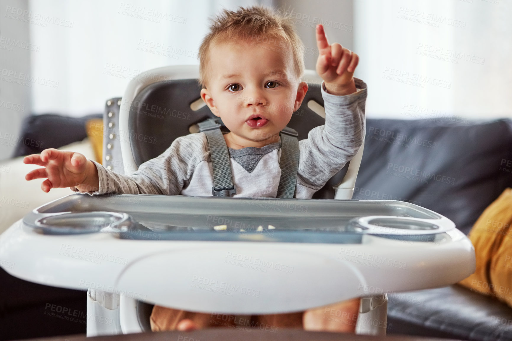 Buy stock photo Baby, high chair and house in portrait for learning or wellness, motor skills with finger for growth. Young, boy child and hand in home for healthy development, waiting for meal time in apartment