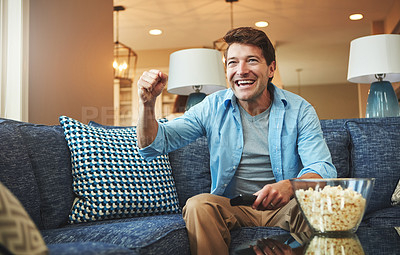 Buy stock photo Smile, man and tv remote with popcorn in home on sofa on day off with watching sports game, challenge and fun. Living room, couch and excited or happy with fist for celebration, win and entertainment