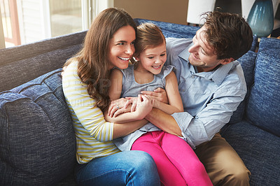 Buy stock photo Shot of parents bonding with their little daughter at home