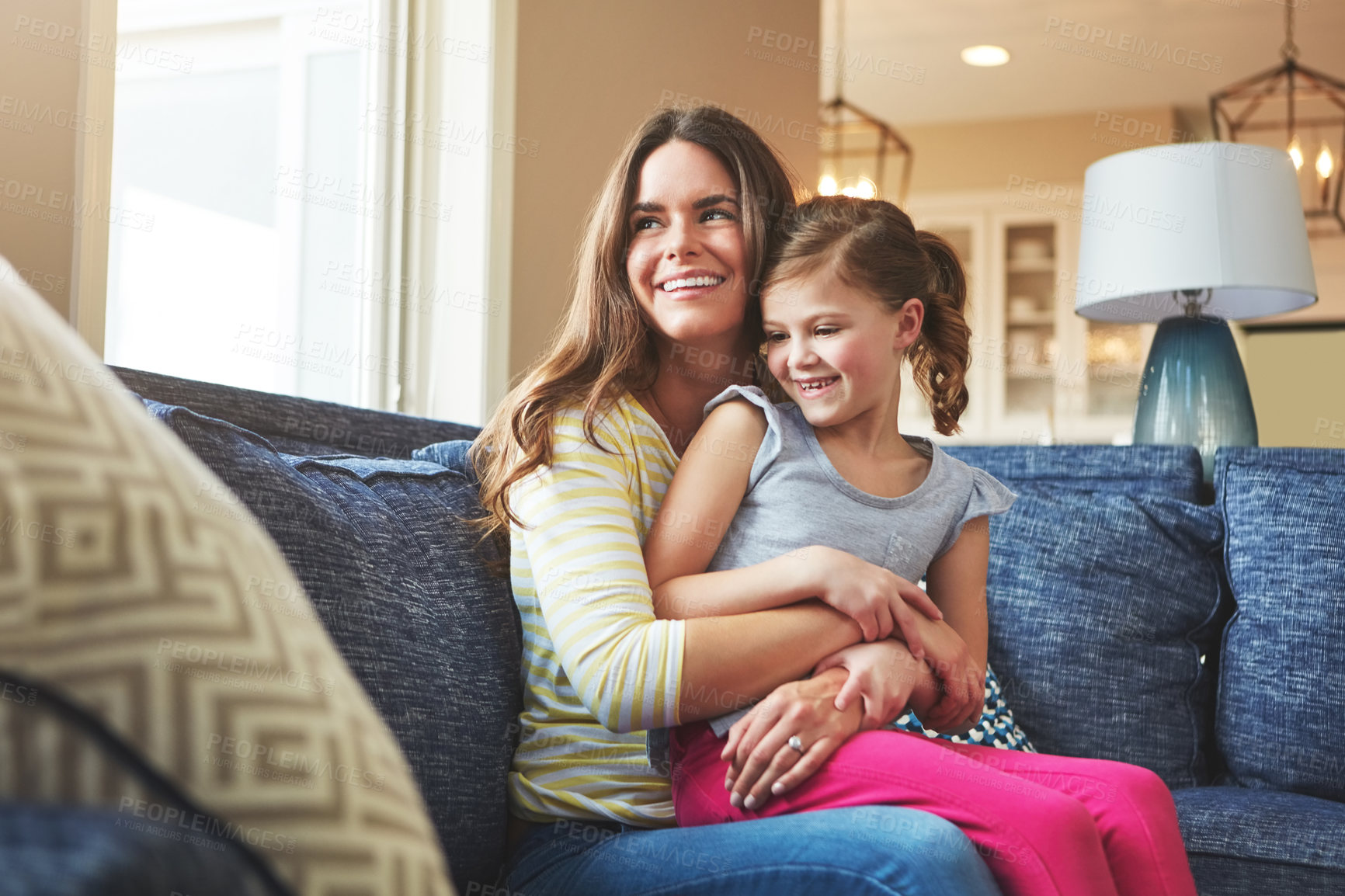 Buy stock photo Mother, girl and hug on sofa with smile for relationship trust and support for care in home. Mama, young child and happy embrace in apartment lounge for love connection and weekend bonding with peace