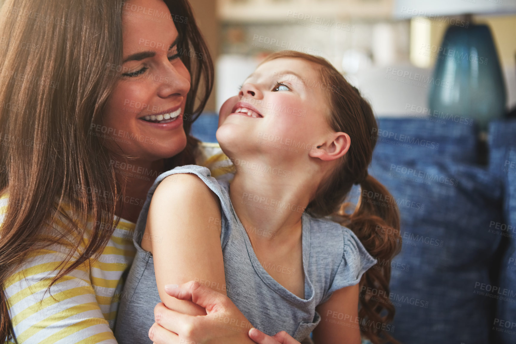 Buy stock photo Woman, hug and child with love on sofa house for trust, bonding and support of relationship moment. Smile, mother and girl as family for care, security or relax with embrace on couch for childhood