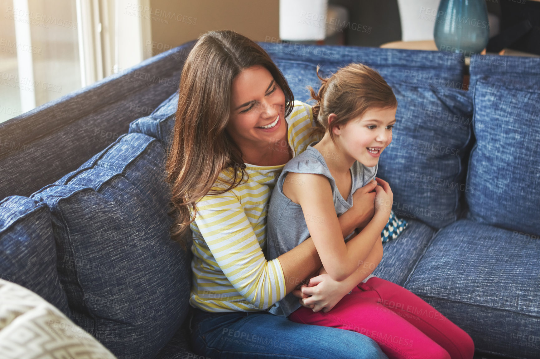 Buy stock photo Mother, girl and hug on couch with smile for relationship trust and support for care in home. Mama, young child and happy embrace on apartment sofa for love connection and bond together with peace