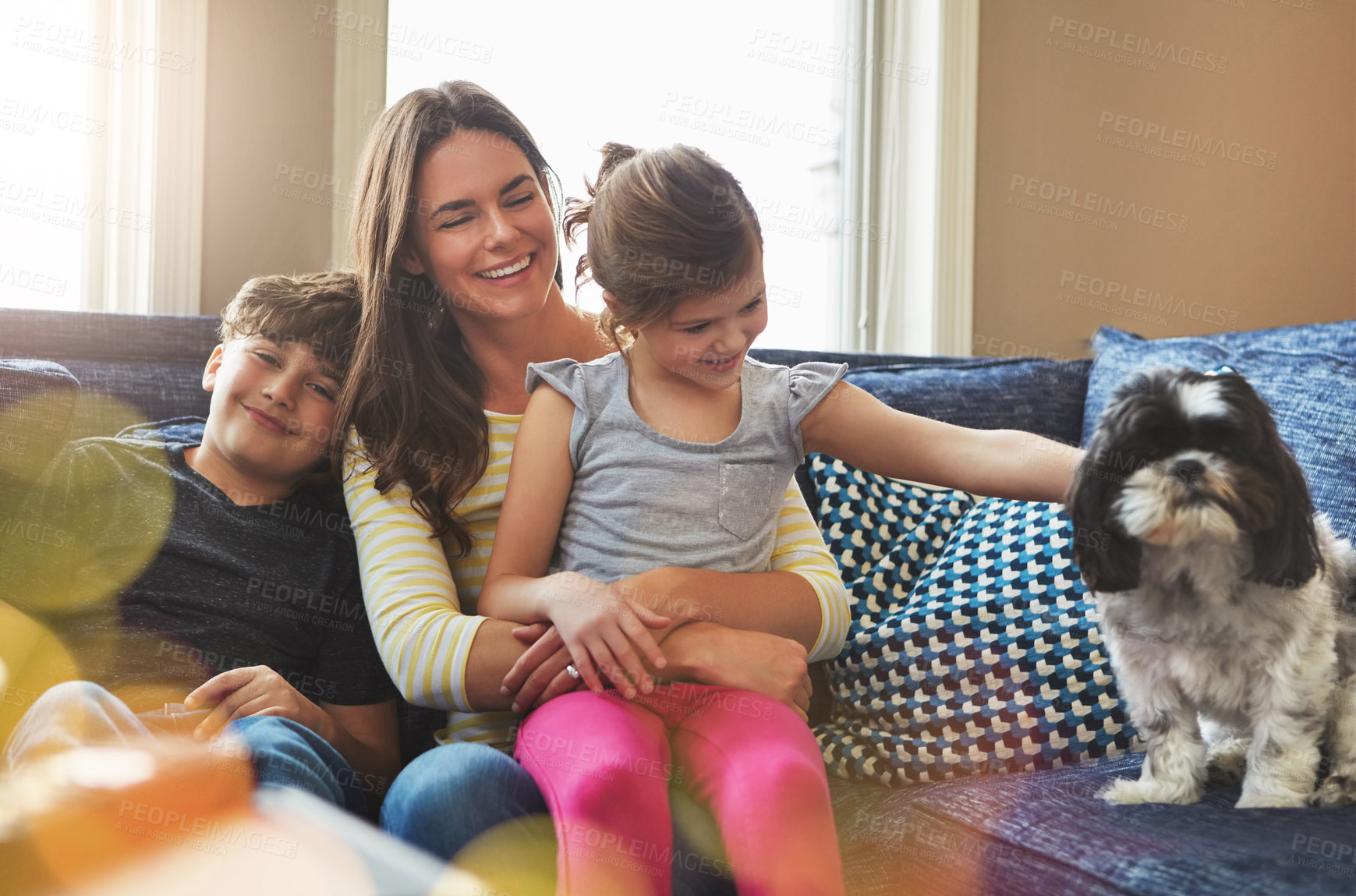 Buy stock photo Shot of a mother bonding with her little son and daughter at home