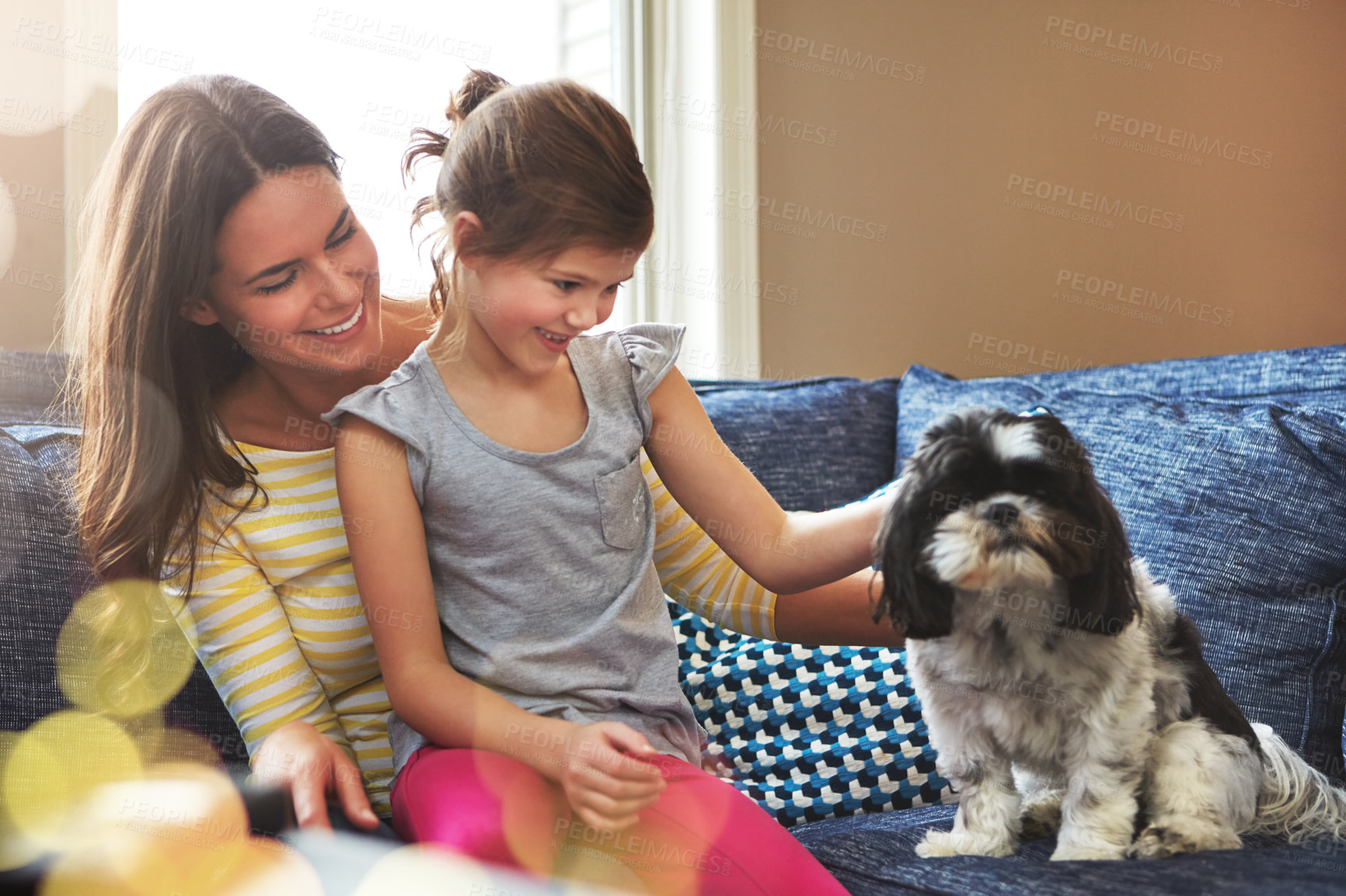 Buy stock photo Shot of an adorable little girl, her mother and their dog spending time together at home