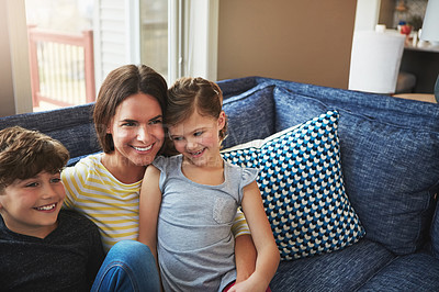 Buy stock photo Shot of a mother bonding with her little son and daughter at home