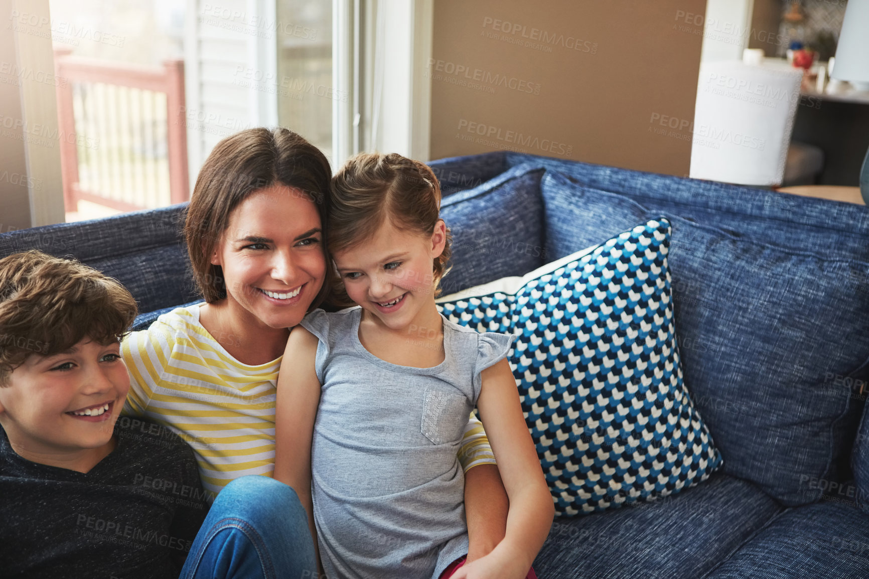 Buy stock photo Shot of a mother bonding with her little son and daughter at home