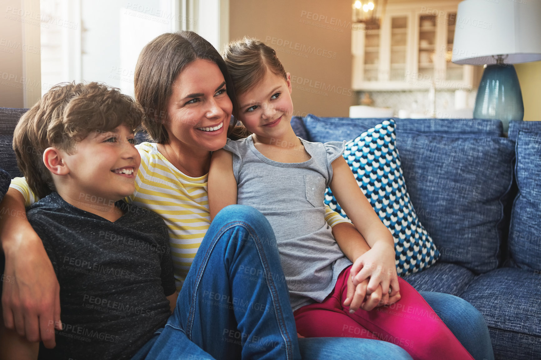 Buy stock photo Shot of a mother bonding with her little son and daughter at home