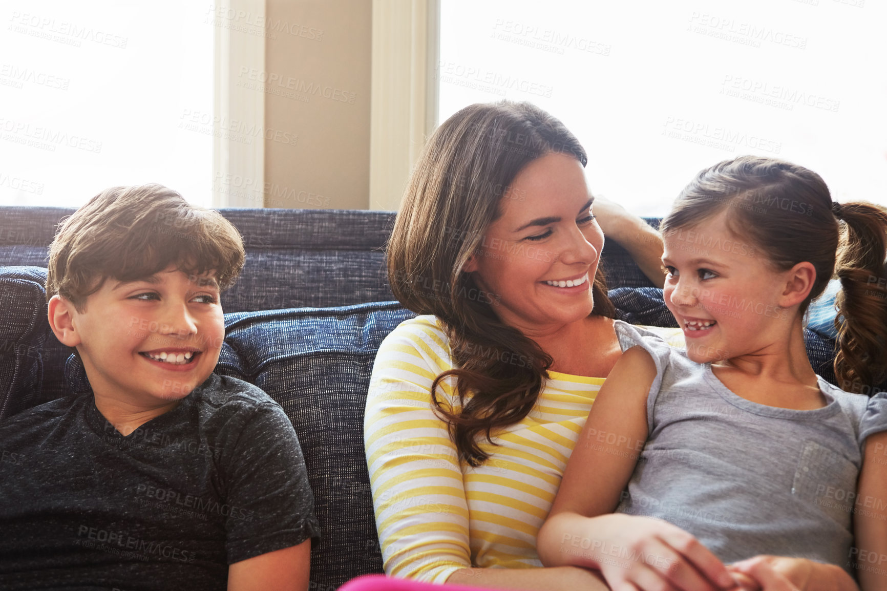 Buy stock photo Shot of a mother bonding with her little son and daughter at home