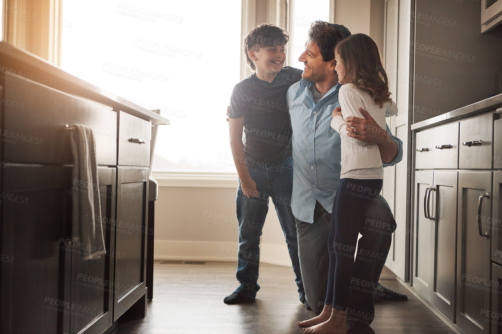 Buy stock photo Father, children and hug in kitchen for talking, love and support for relationship in home. Man, kids and together in embrace for care or security, speaking and bonding in family house for comfort