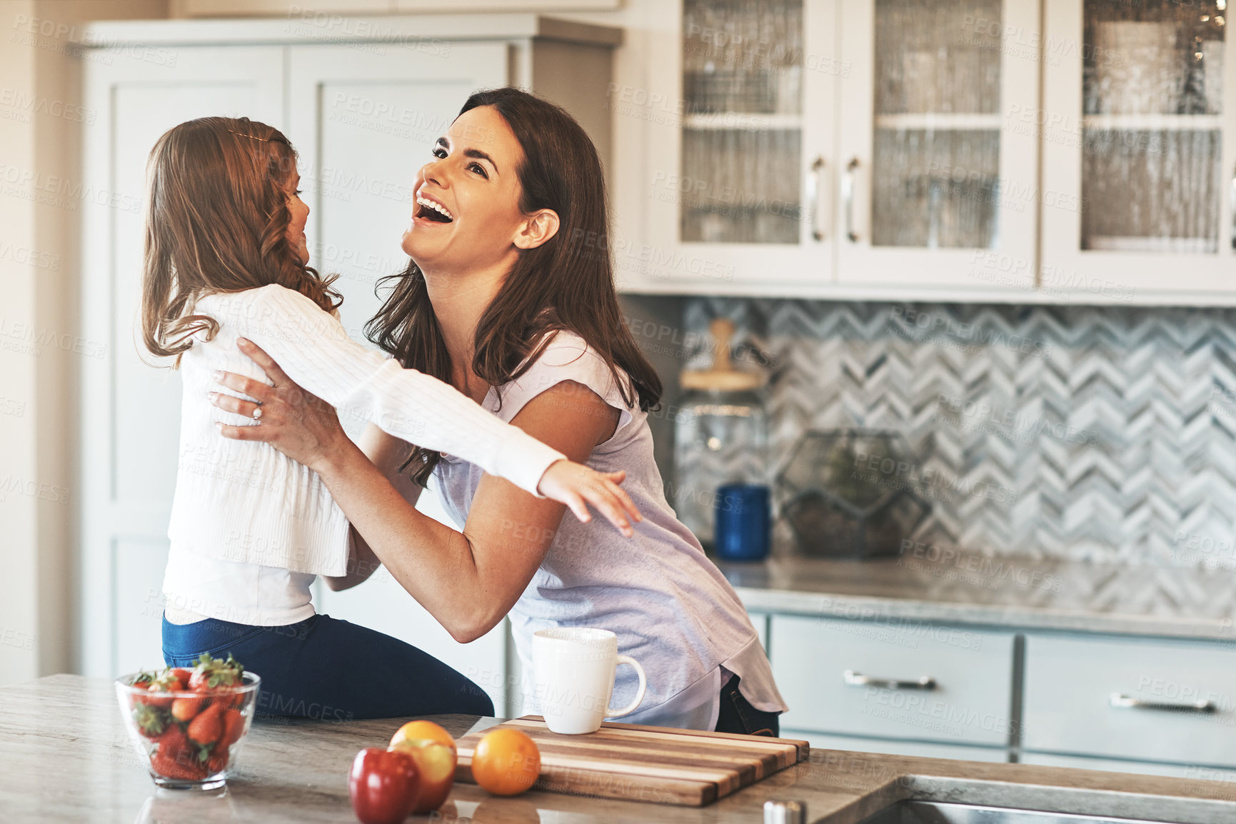 Buy stock photo Happy, mother and hug with girl, kitchen counter or bonding in weekend, house and kid with smile. Home, child and mom with daughter, embrace and together in morning, peace or love in apartment