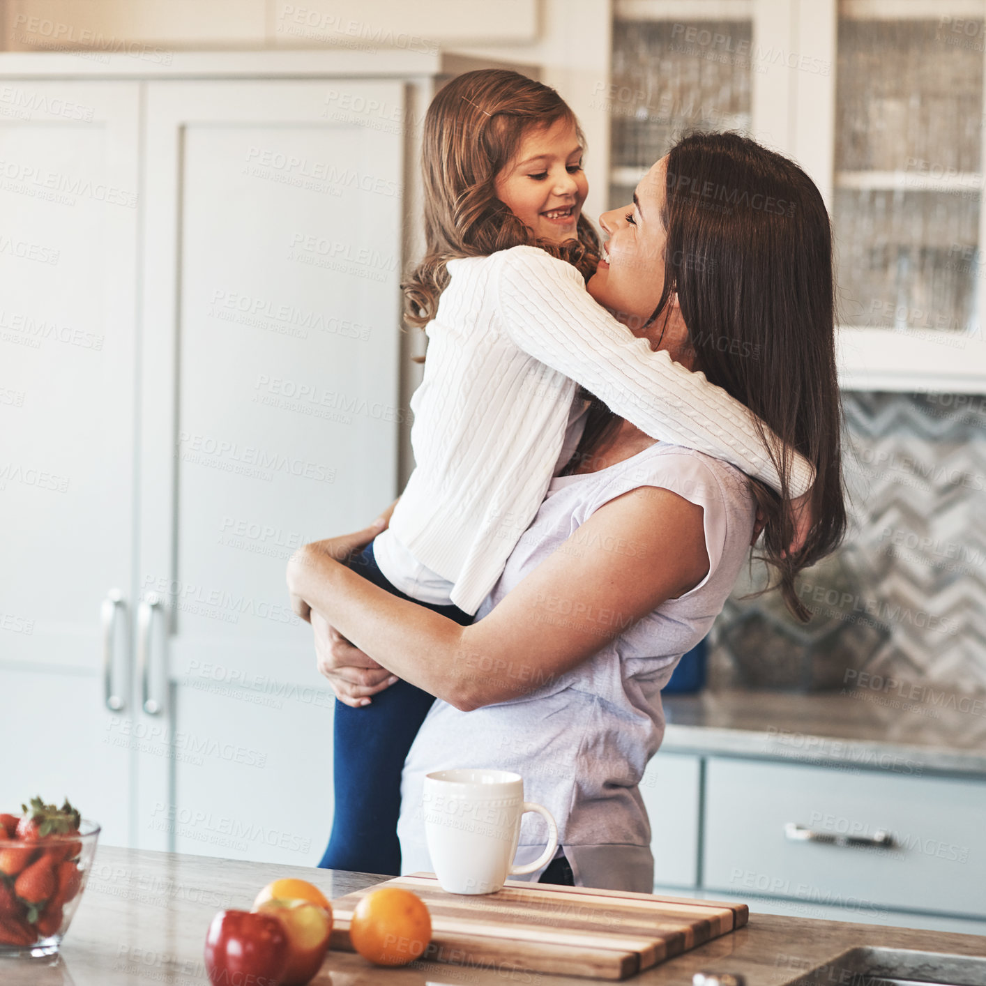 Buy stock photo Bonding, mother and hug with girl, kitchen counter or smile in weekend, house and kid with love. Home, child and mom with daughter, embrace and together in morning, peace or breakfast in apartment