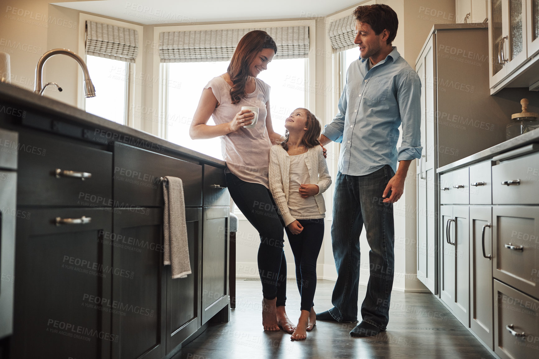 Buy stock photo Parents, girl and hug in kitchen for talking, love and support for relationship in home. Mother and father, daughter and together in embrace for care or security, speaking and bonding in family house