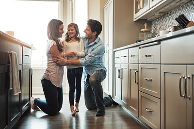 Buy stock photo Parents, girl and hug in kitchen for love, conversation and support for relationship in home. Mother and father, daughter and together in embrace for security, speaking and bonding in family house