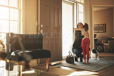 Buy stock photo Shot of a happy mother arriving home to a loving welcome from her daughter