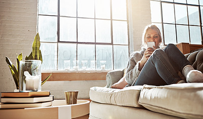 Buy stock photo Living room, phone or relax and a woman in her home, sitting on the sofa with the sun shine through the window. Weekend, social media and communication with a young female relaxing in her house