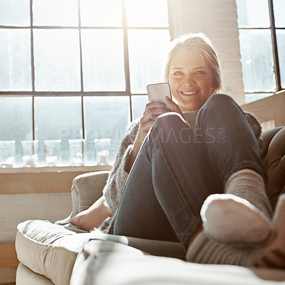 Buy stock photo Phone, portrait and happy woman in home living room for social media, news and email. Smartphone, smile and girl relax on sofa to scroll on app, blog and chat on mobile website on internet in house