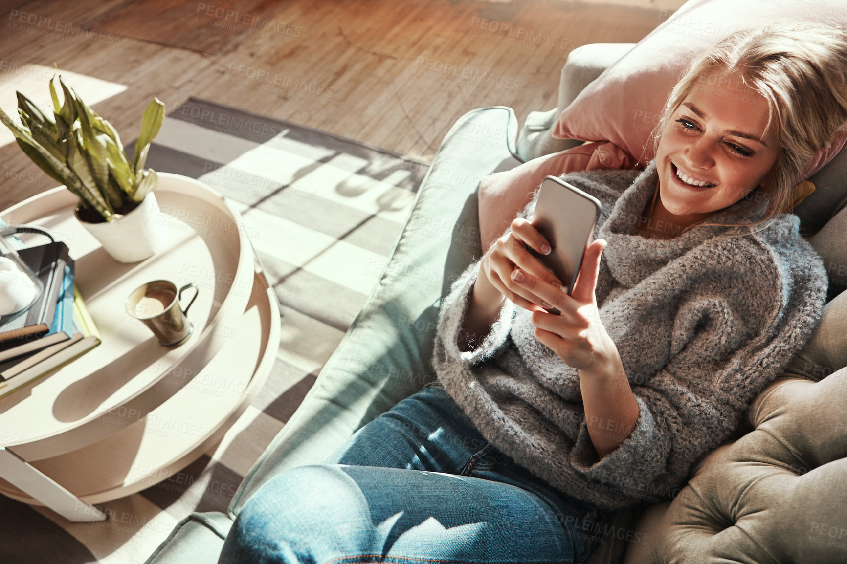 Buy stock photo Smile, sofa and woman at home on a phone in a living room calm on social media with happiness. House couch, lounge and person relax on a mobile online on wifi looking happy from streaming web content