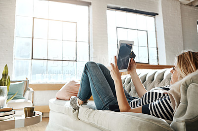 Buy stock photo Young woman, tablet or happy with search in home on sofa, reading news or story on social media. Female student, apartment or message with internet for online conversation, technology for chat