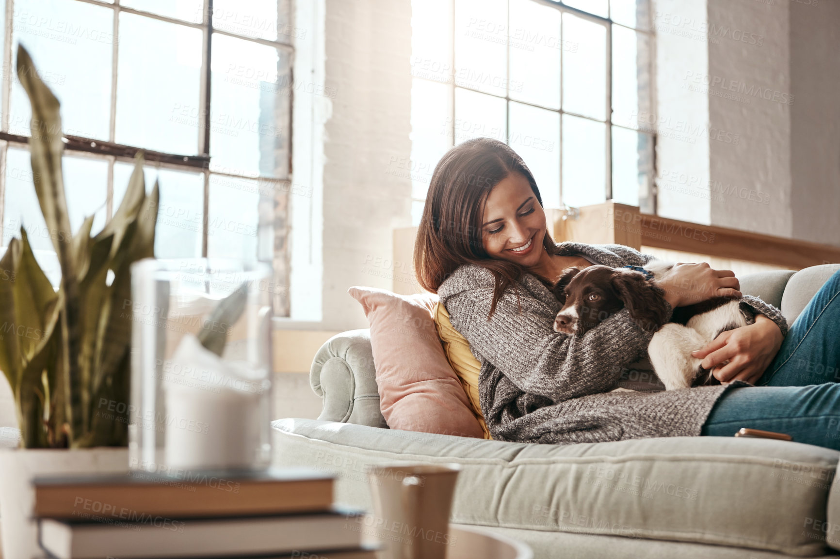 Buy stock photo Smile, dog and woman on a couch, relax and love with joy, playful and carefree at home. Female person, girl and lady on a sofa, pet and happiness on a sofa, freedom and break with a domestic animal