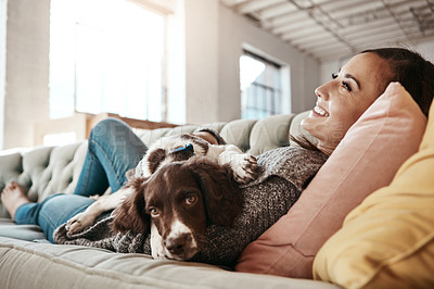 Buy stock photo Happy, bonding and woman with dog on sofa relaxing with pet in living room at apartment. Smile, animal and female person cuddle, hug and embrace puppy with love and care on couch in lounge at home