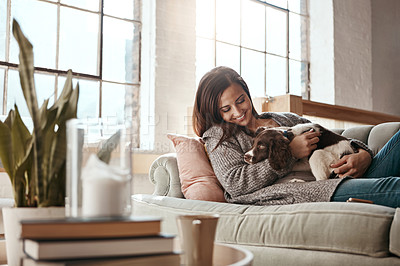 Buy stock photo Woman relax on couch with puppy, happy and content at home with pet, happiness together with peace in living room. 
Female cuddle dog, love for animals with smile and care, stress relief and comfort