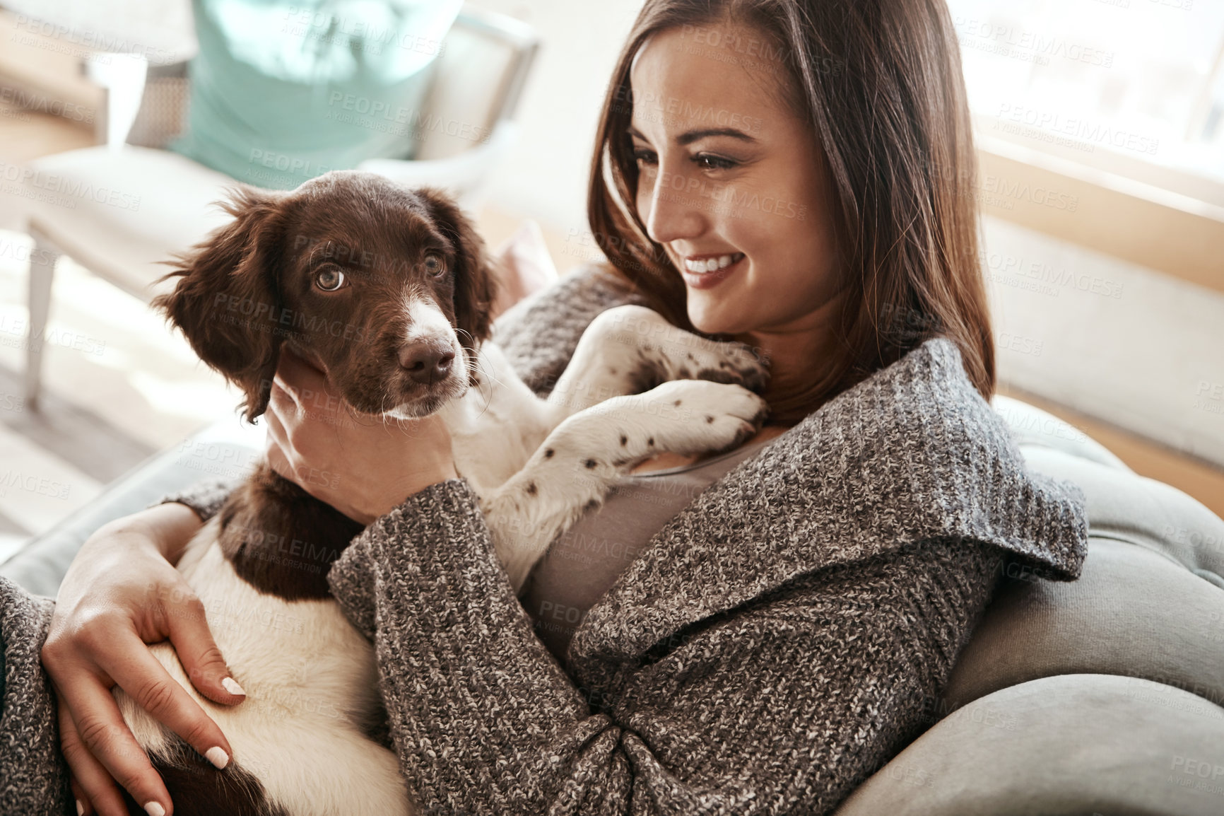 Buy stock photo Love, relaxing and woman with dog on sofa bonding with pet in living room at apartment. Smile, animal and happy female person cuddle, hug and embrace puppy with care on couch in lounge at home.