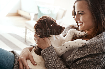 Buy stock photo Smile, happy and woman with dog on sofa bonding with pet in living room at apartment. Relaxing, animal and female person cuddle, hug and embrace puppy with love and care on couch in lounge at home.