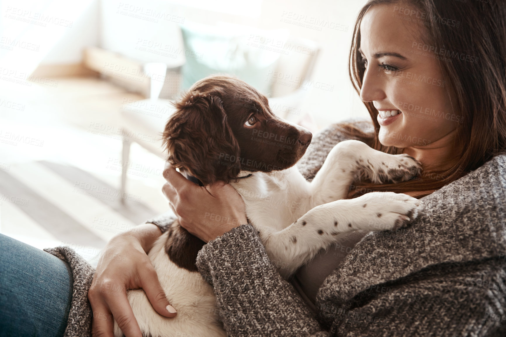 Buy stock photo Smile, happy and woman with dog on sofa bonding with pet in living room at apartment. Relaxing, animal and female person cuddle, hug and embrace puppy with love and care on couch in lounge at home.