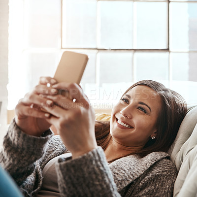 Buy stock photo Relax, smile and woman with smartphone on sofa at home for online network, post and social media. Happy, person and internet with tech in living room for digital blog, connectivity or reading message