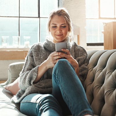 Buy stock photo Woman, sofa and smartphone on social media, reading or communication on internet to relax in lounge. Girl, couch and chat with phone, mobile tech or online dating for partner, love or romance in home