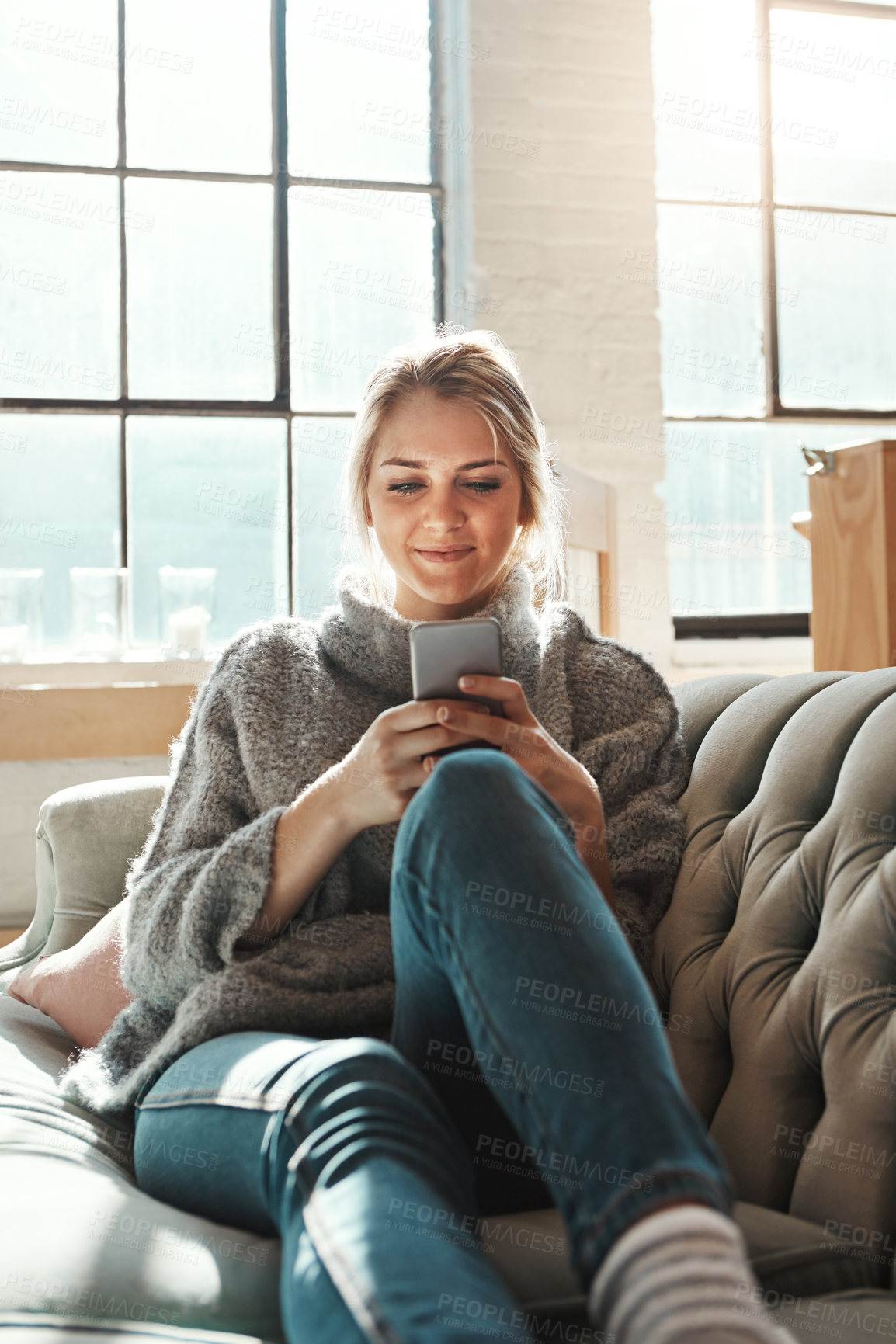 Buy stock photo Phone, relax and woman in home living room for social media, news and reading email. Smartphone, technology and girl on sofa to scroll on app, blog and chat on mobile website on internet in house