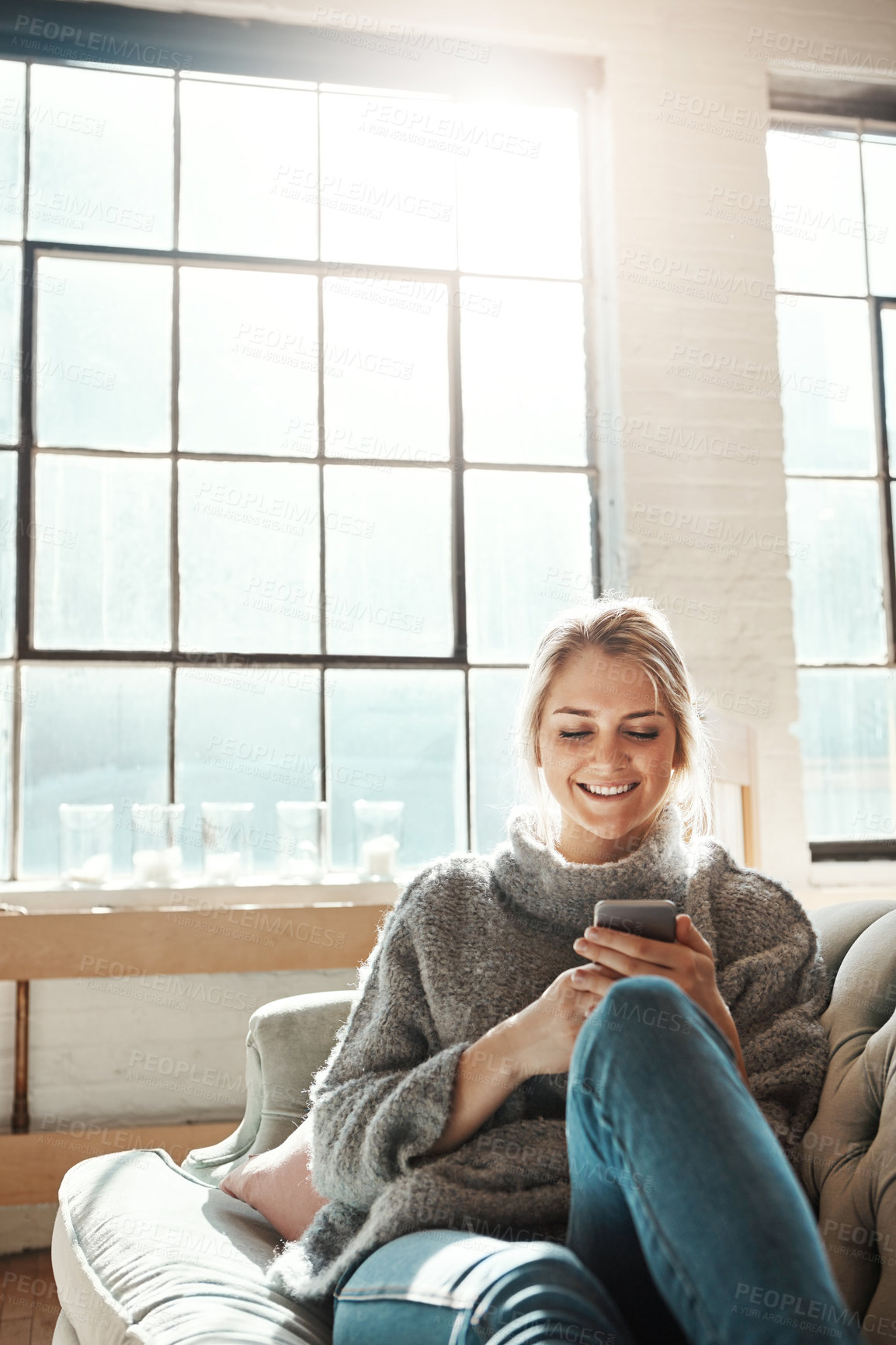 Buy stock photo Phone, smile and woman in home on sofa for social media, news and reading email. Smartphone, relax and happy girl in living room to scroll on app, blog and chat on mobile website on internet in house