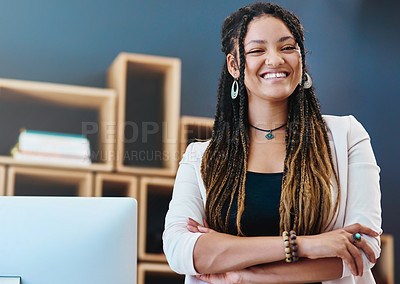 Buy stock photo Cropped portrait of an attractive young woman standing with her arms crossed in her home office