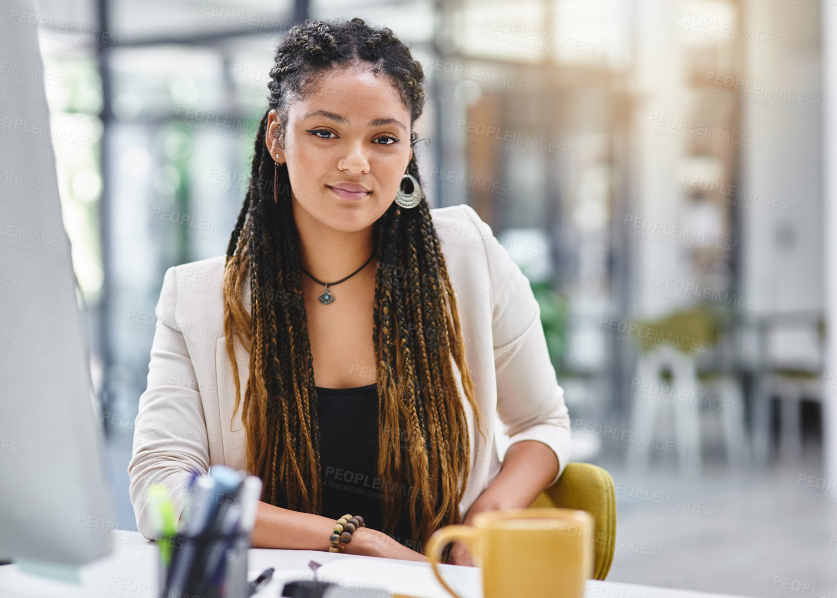 Buy stock photo Cropped portrait of an attractive young businesswoman sitting at her desk in the office