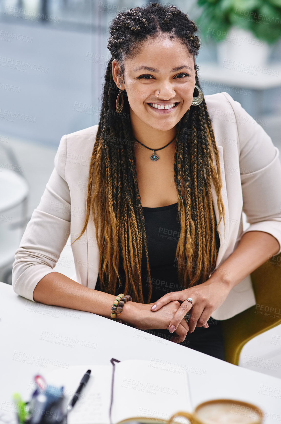 Buy stock photo High angle portrait of an attractive young businesswoman sitting at her desk in the office