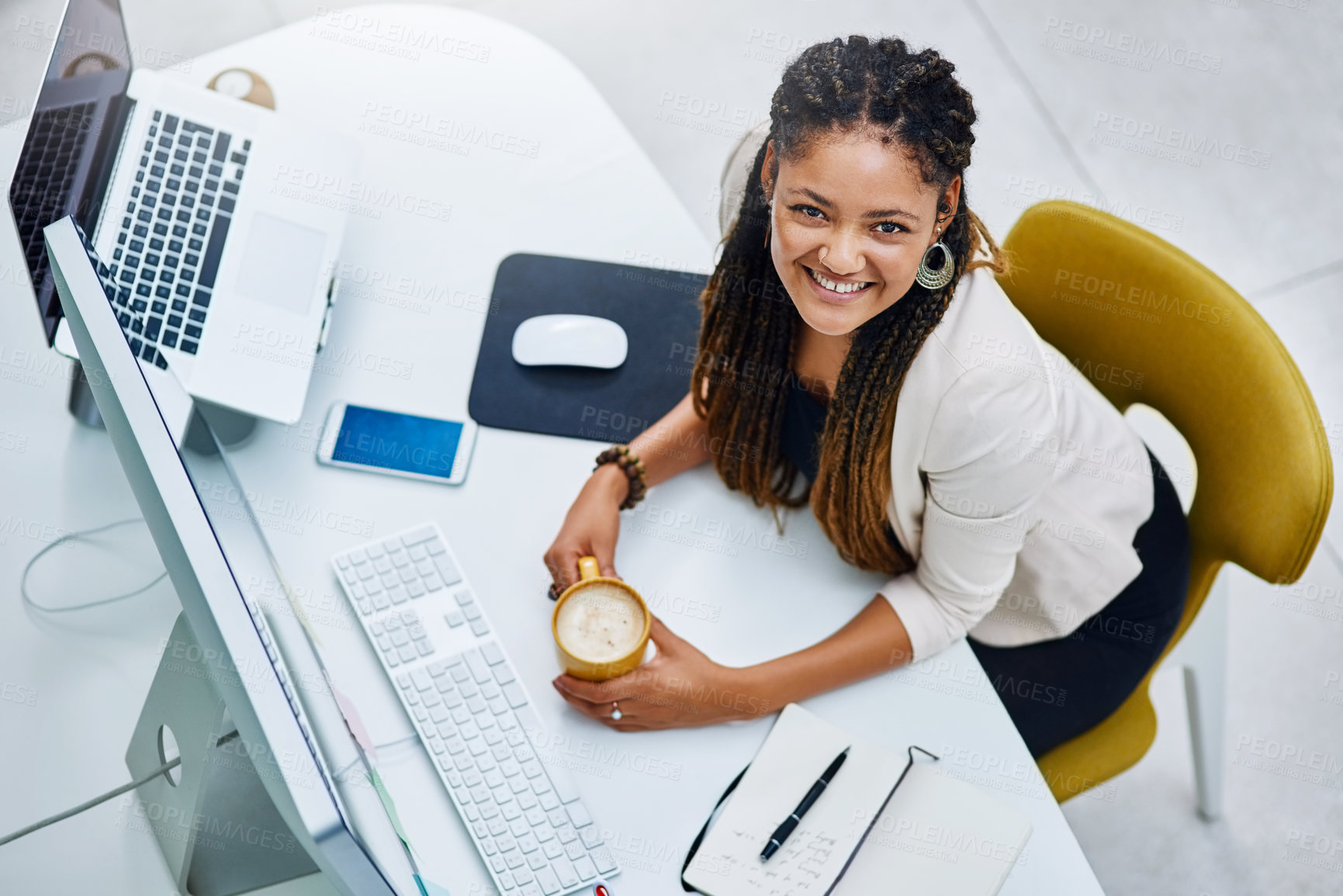 Buy stock photo High angle portrait of an attractive young businesswoman sitting at her desk in the office