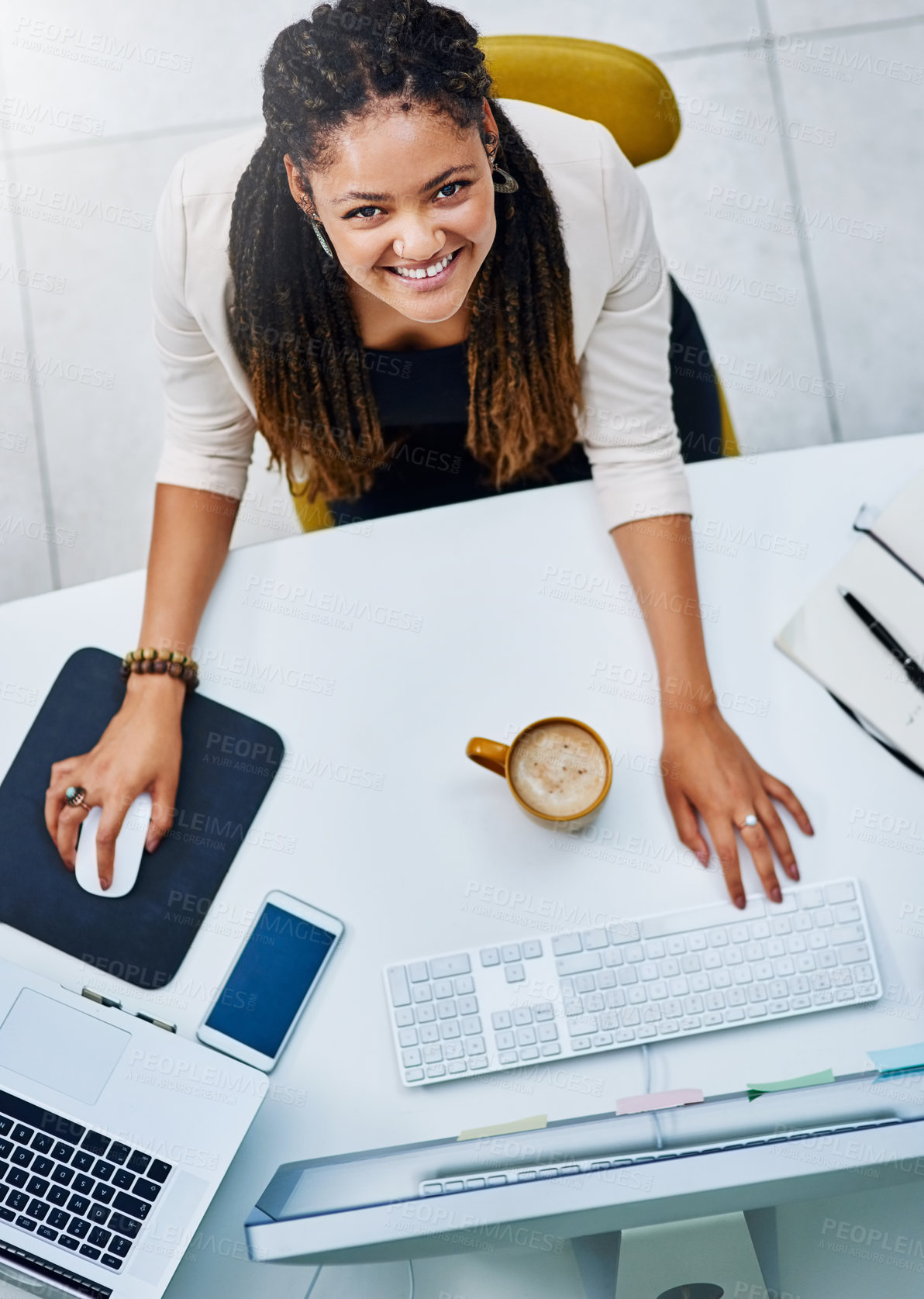 Buy stock photo High angle portrait of an attractive young businesswoman working at her desk in the office