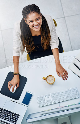 Buy stock photo High angle portrait of an attractive young businesswoman working at her desk in the office