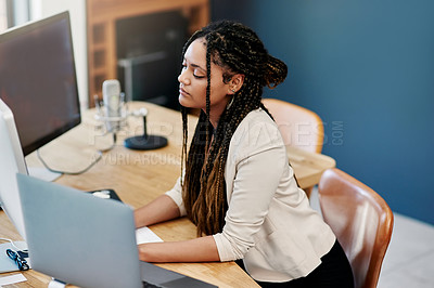 Buy stock photo High angle shot of an attractive young woman working on a computer in her home office